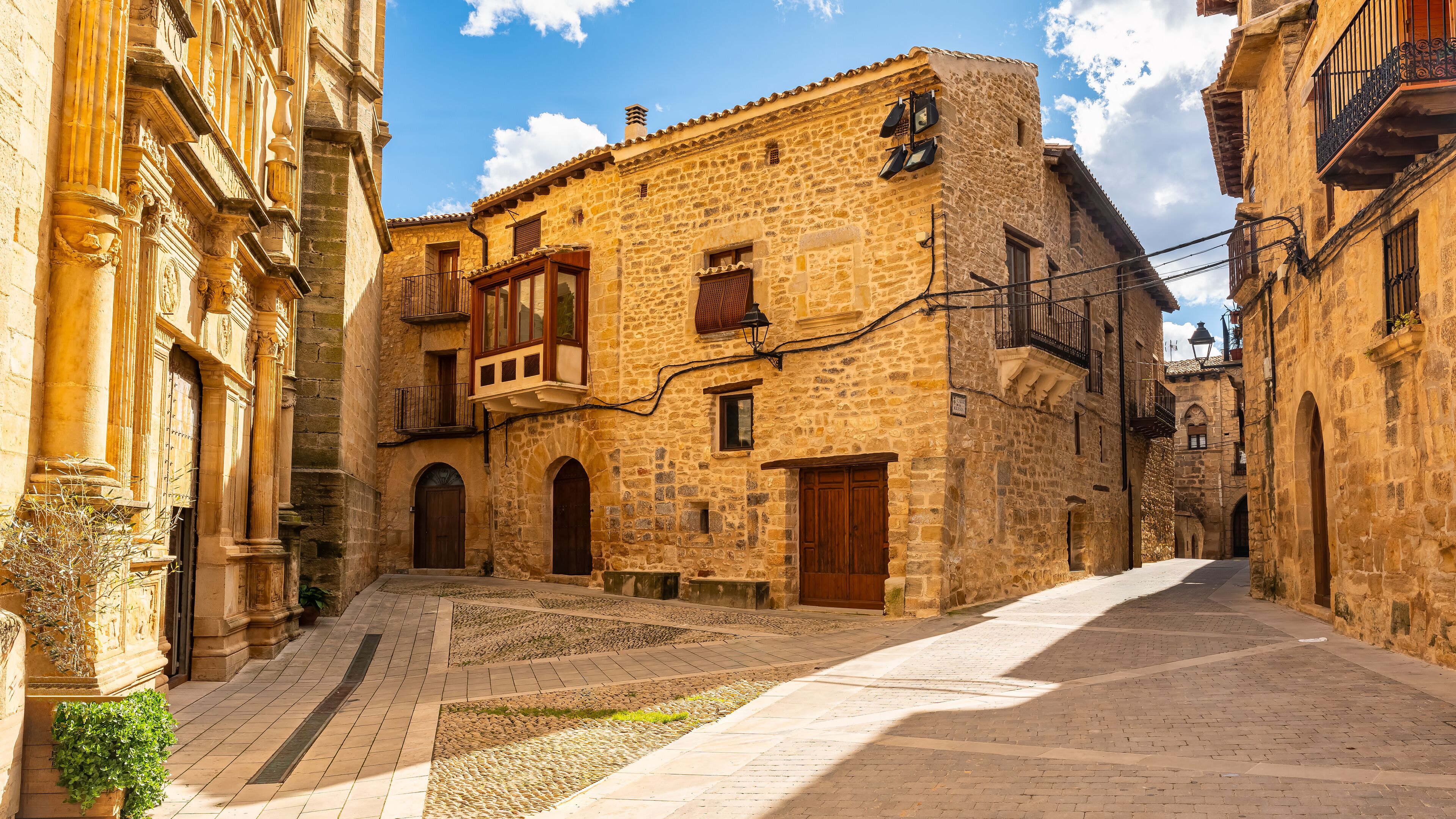 Square with church and medieval houses in the pretty village of Cretas, Matarrana, Teruel.