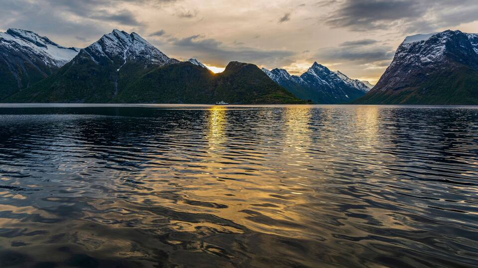 A mountain range with a lake reflecting the peaks.