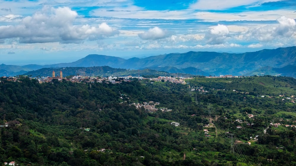 A mountainous landscape with a town nestled among the hills.