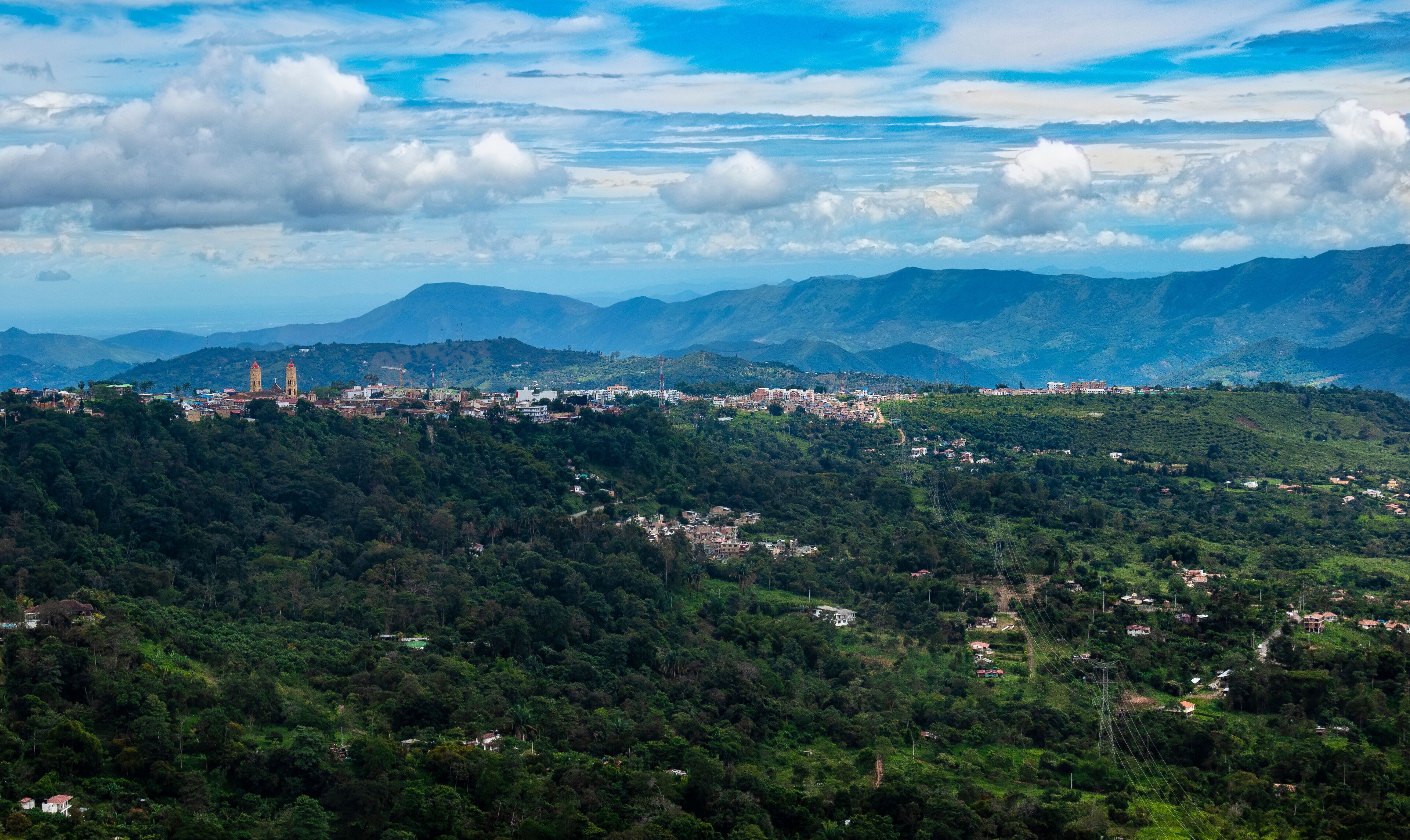 A mountainous landscape with a town nestled among the hills.