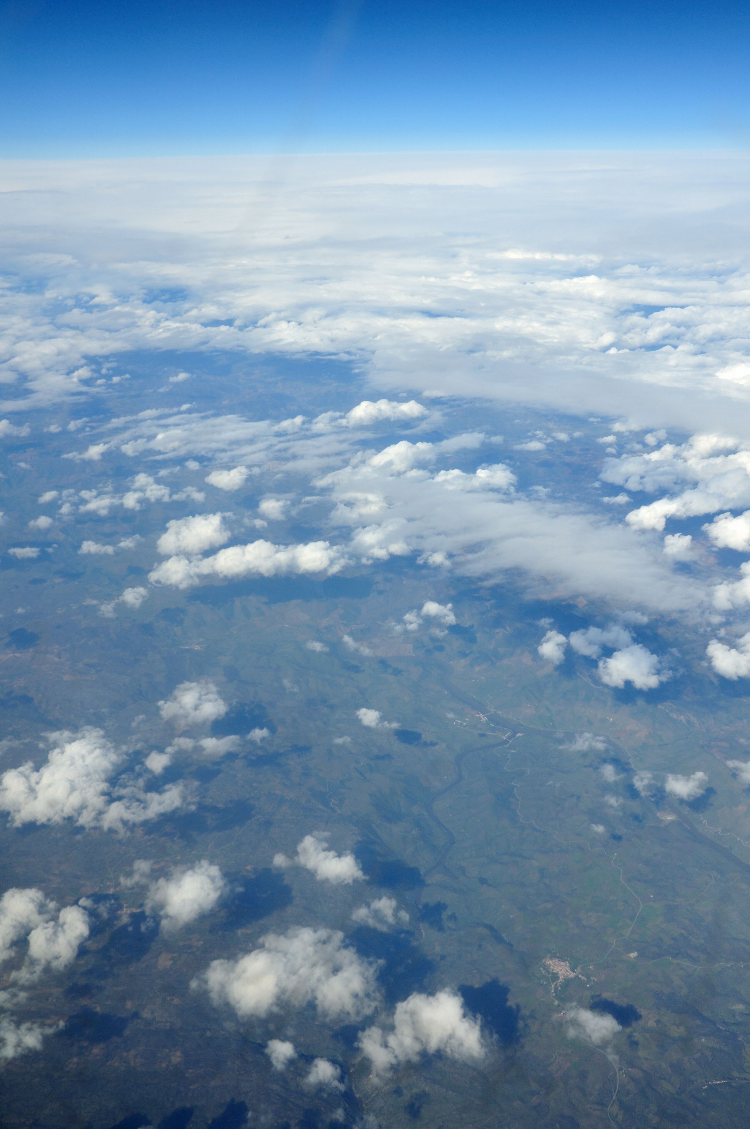 A view of the sky and clouds from an airplane window.
