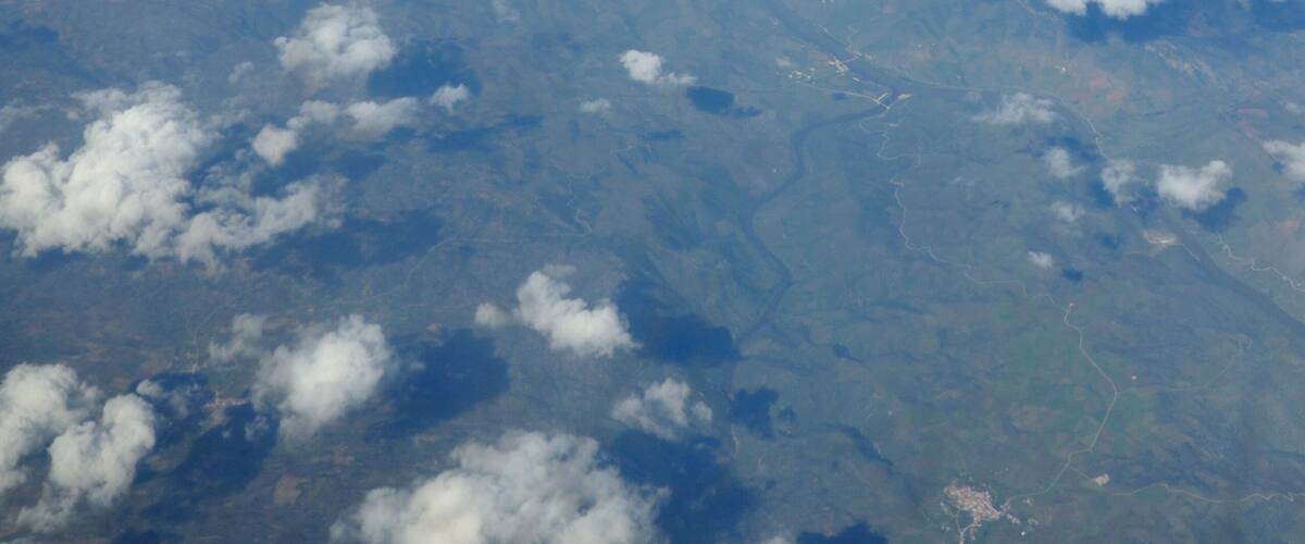 A view of the sky and clouds from an airplane window.