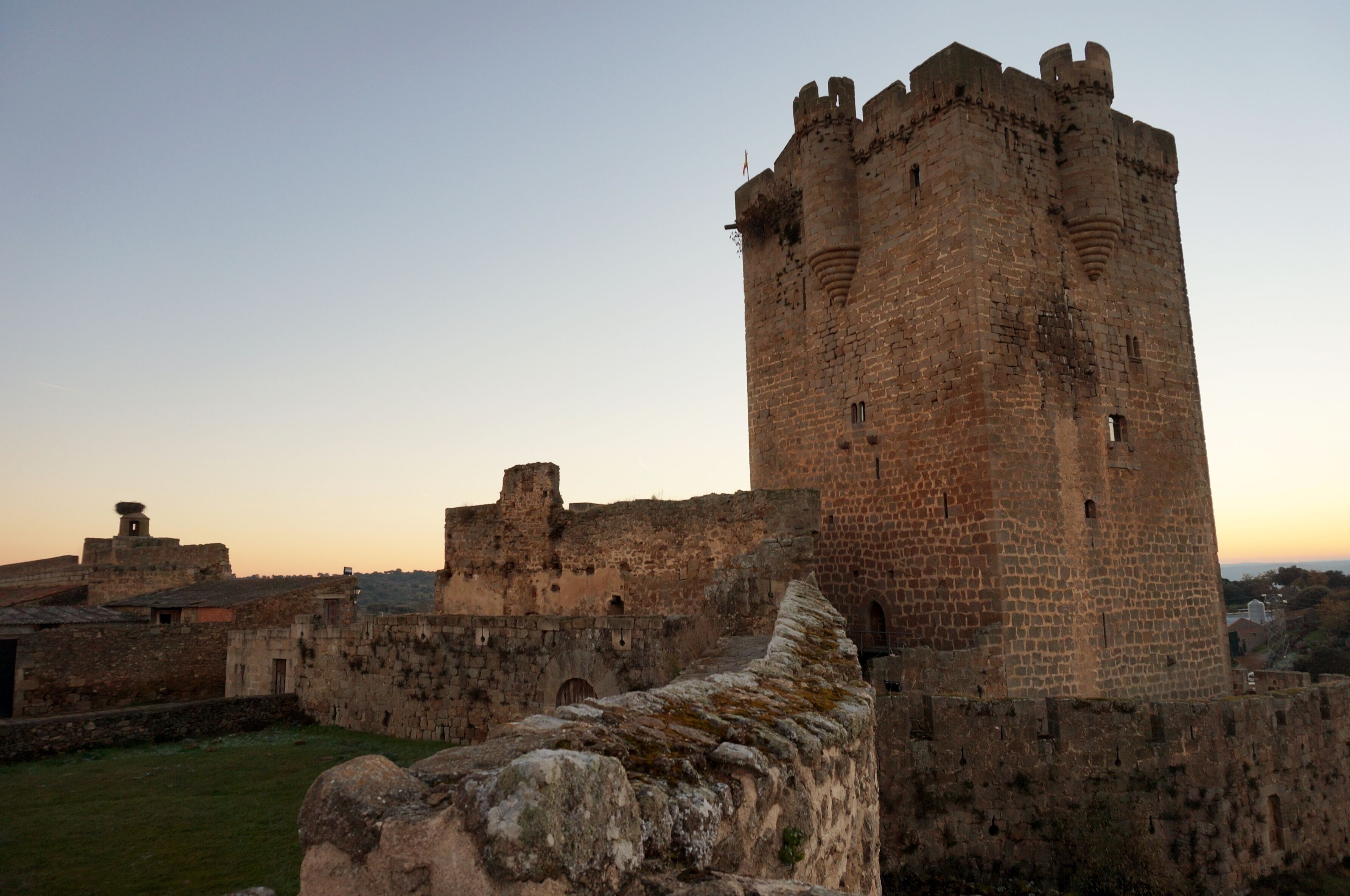 A medieval castle with a prominent tower and surrounding walls.