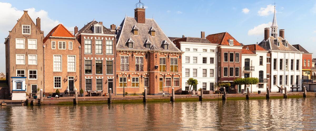 A canal with historic buildings reflecting on the water.