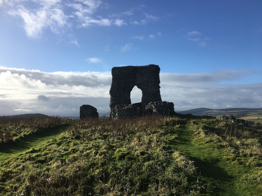 The 13th century castle ruins are the most obvious evidence of fortifications on the hill, but much older walls encircle the site! Park your car in the lay-by and take a short steep trek up the hill.