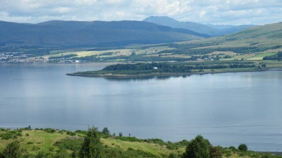 A lake surrounded by hills and a small island.