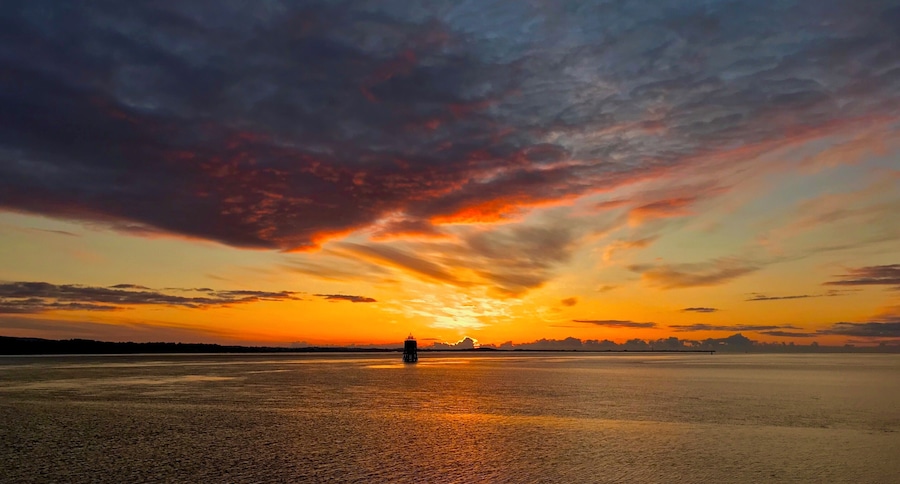Sunrise from the pier in Tayport Fife Scotland, The Tayport pile lighthouse known as the "East Lighthouse" is one of only three surviving Pile Lighthouses in the United Kingdom.