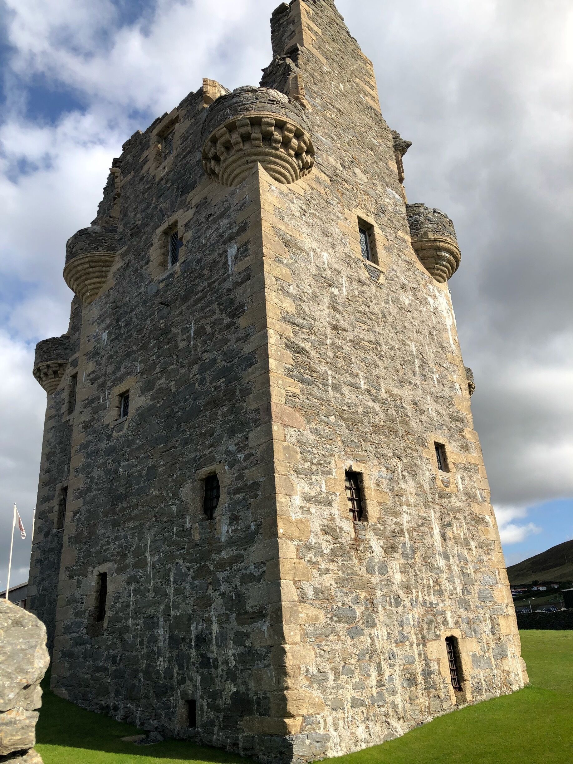 A historic stone tower with crenellations and multiple windows.