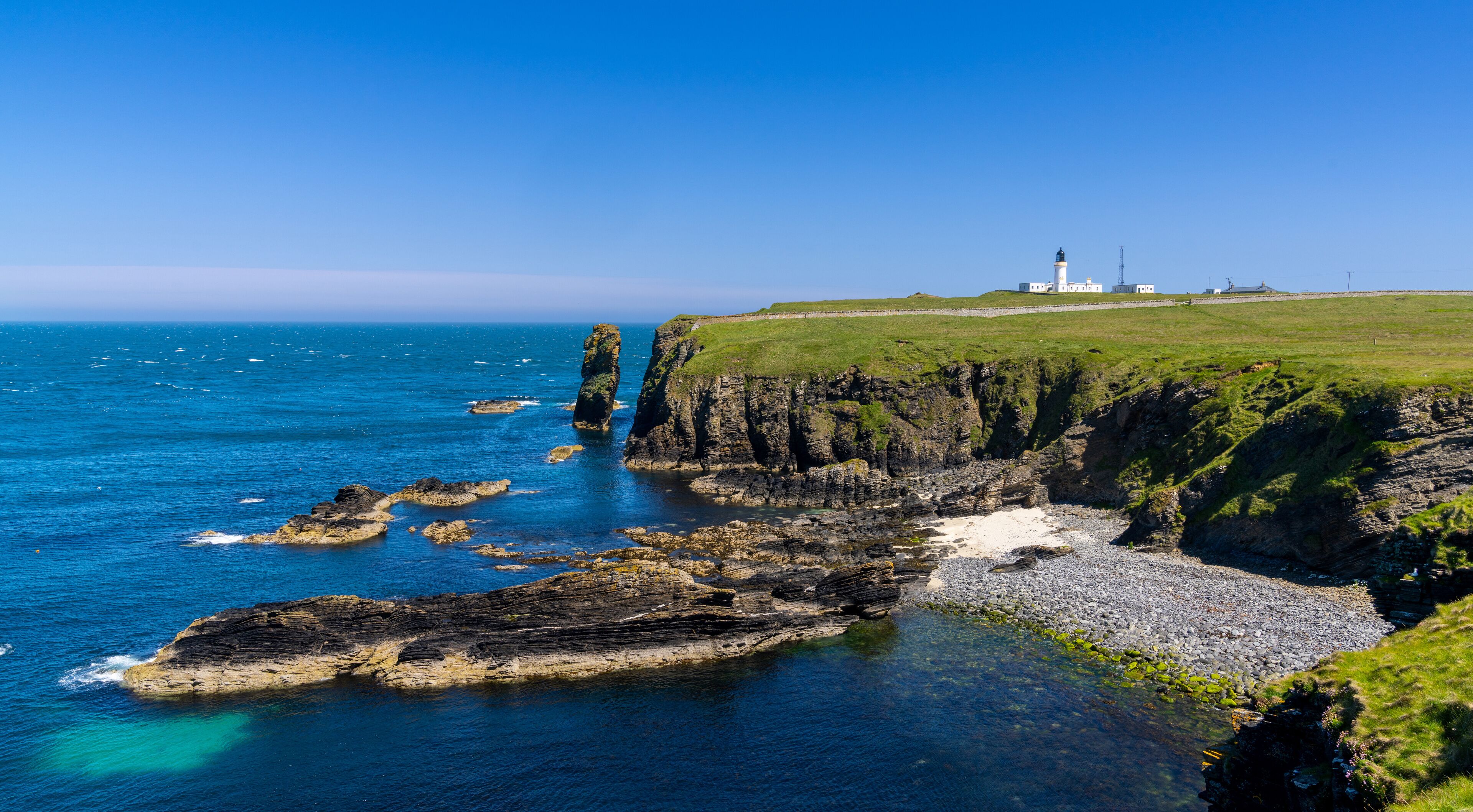 panorama view of the wild Caithness coast and the Noss Head Lighthouse