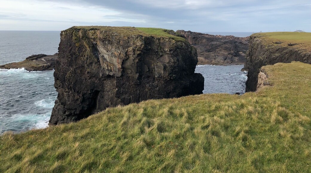 No warning signs along the path. Vast expanses of green and sky.