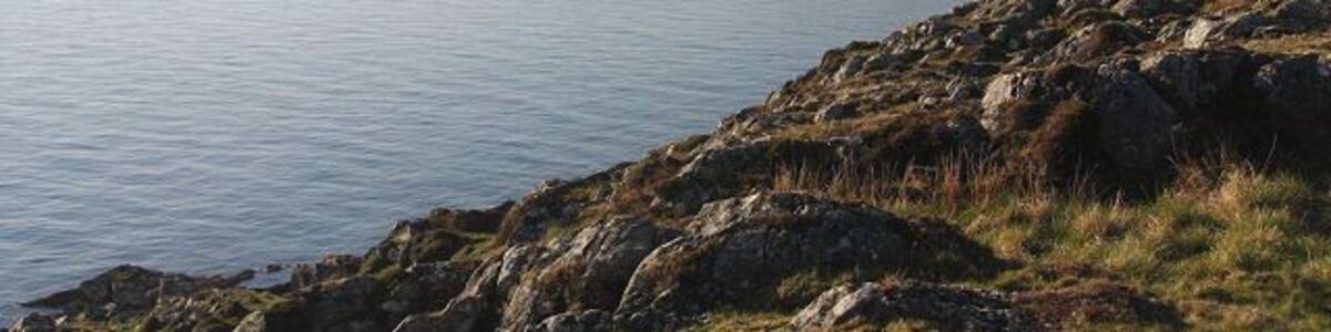 View from southern tip of Gigha Looking back across Gròb Bàgh from the highest point on Gigha's southern tip. In the distance the Paps of Jura can just be seen.