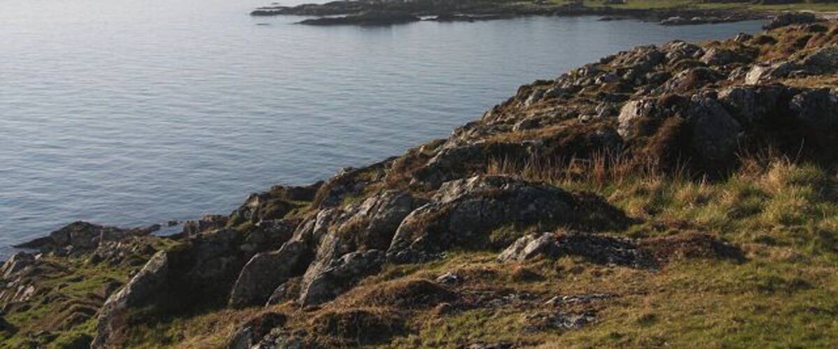 View from southern tip of Gigha Looking back across Gròb Bàgh from the highest point on Gigha's southern tip. In the distance the Paps of Jura can just be seen.