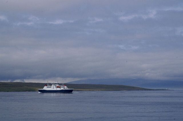 Looking towards Mio Ness The small light on Mio Ness can just be made out, in front of a mist-covered Ronas Hill; the Yell Sound ferry is passing closer in.