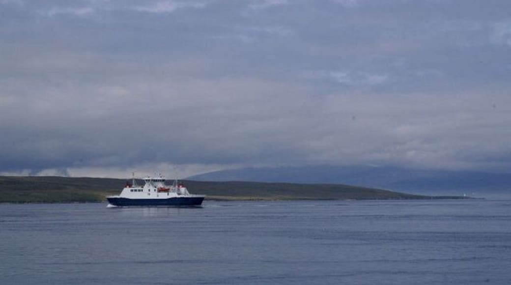 Looking towards Mio Ness The small light on Mio Ness can just be made out, in front of a mist-covered Ronas Hill; the Yell Sound ferry is passing closer in.