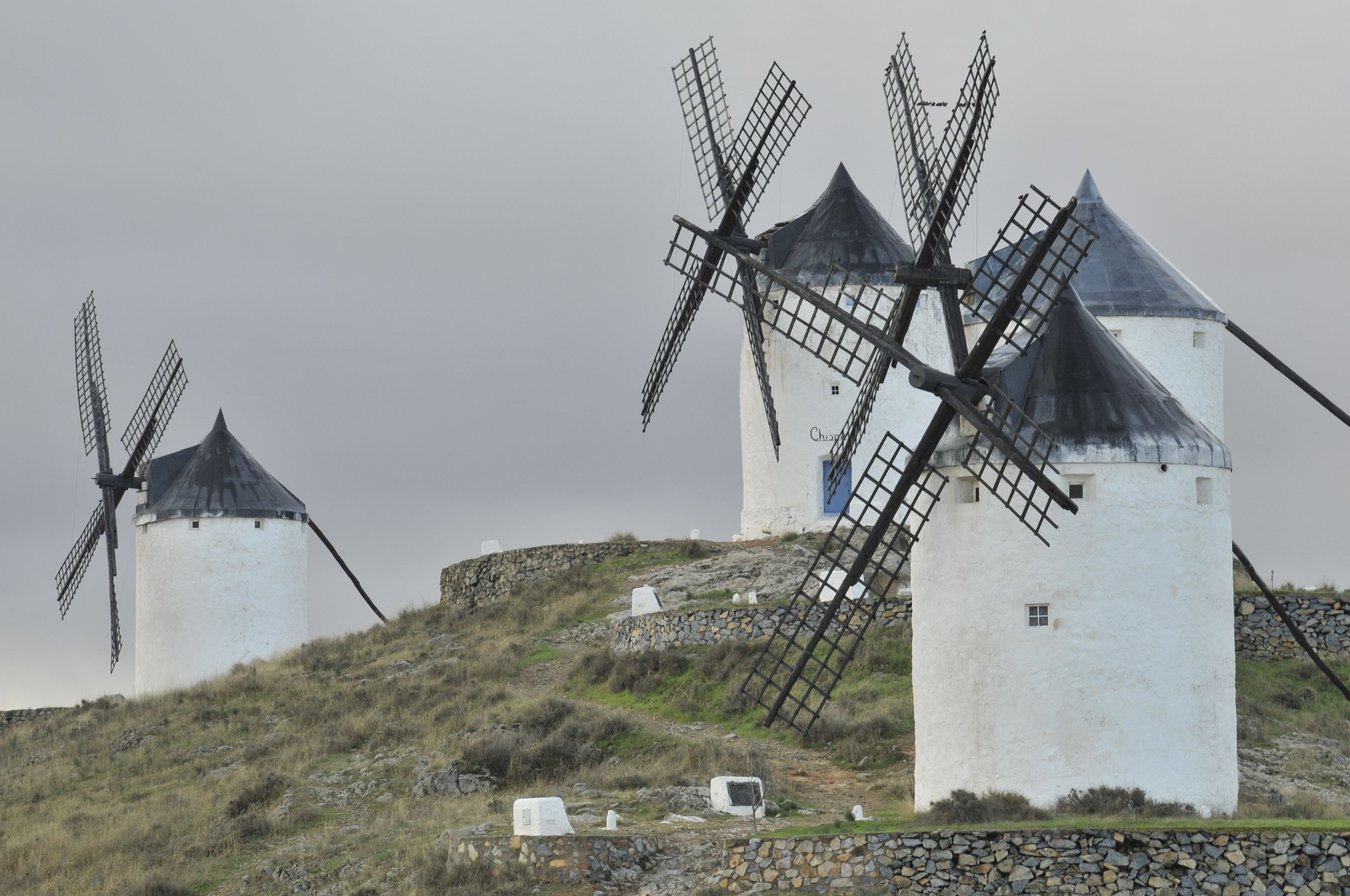 Three windmills on a hill.