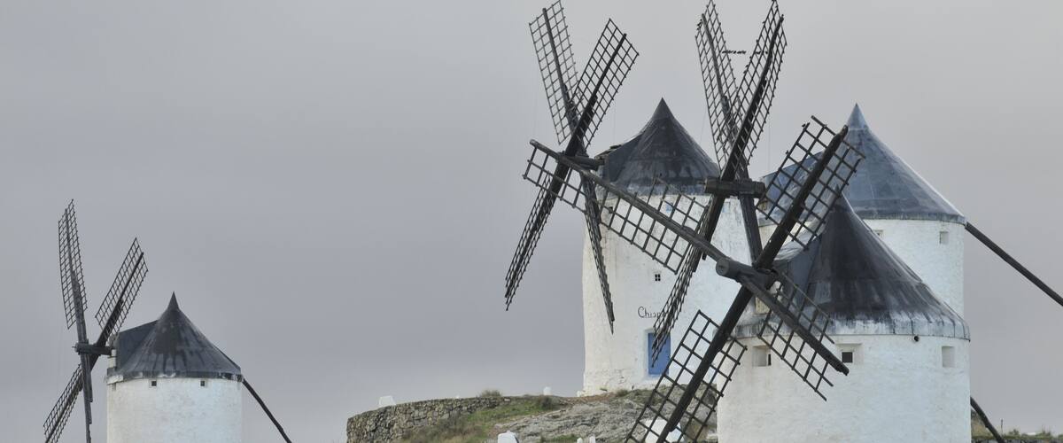Three windmills on a hill.
