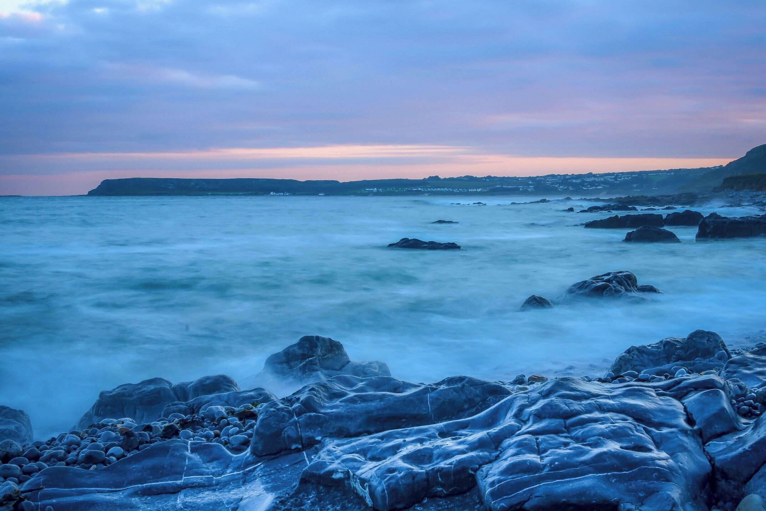 At sunset, looking towards Port Eynon on the Gower Peninsular near Swansea in Wales. The mix of colours may appear calming but the reality was something quite different. The incoming tide in this area is ferocious.   