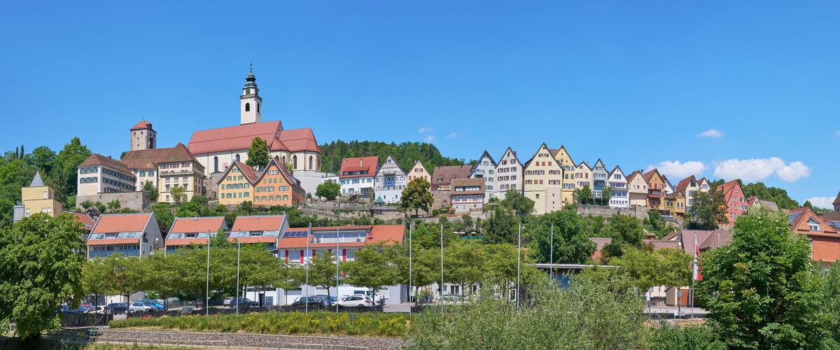A town with colorful houses, a church, and a tower.