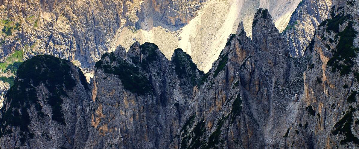 A rugged mountain landscape with steep cliffs and a narrow valley.