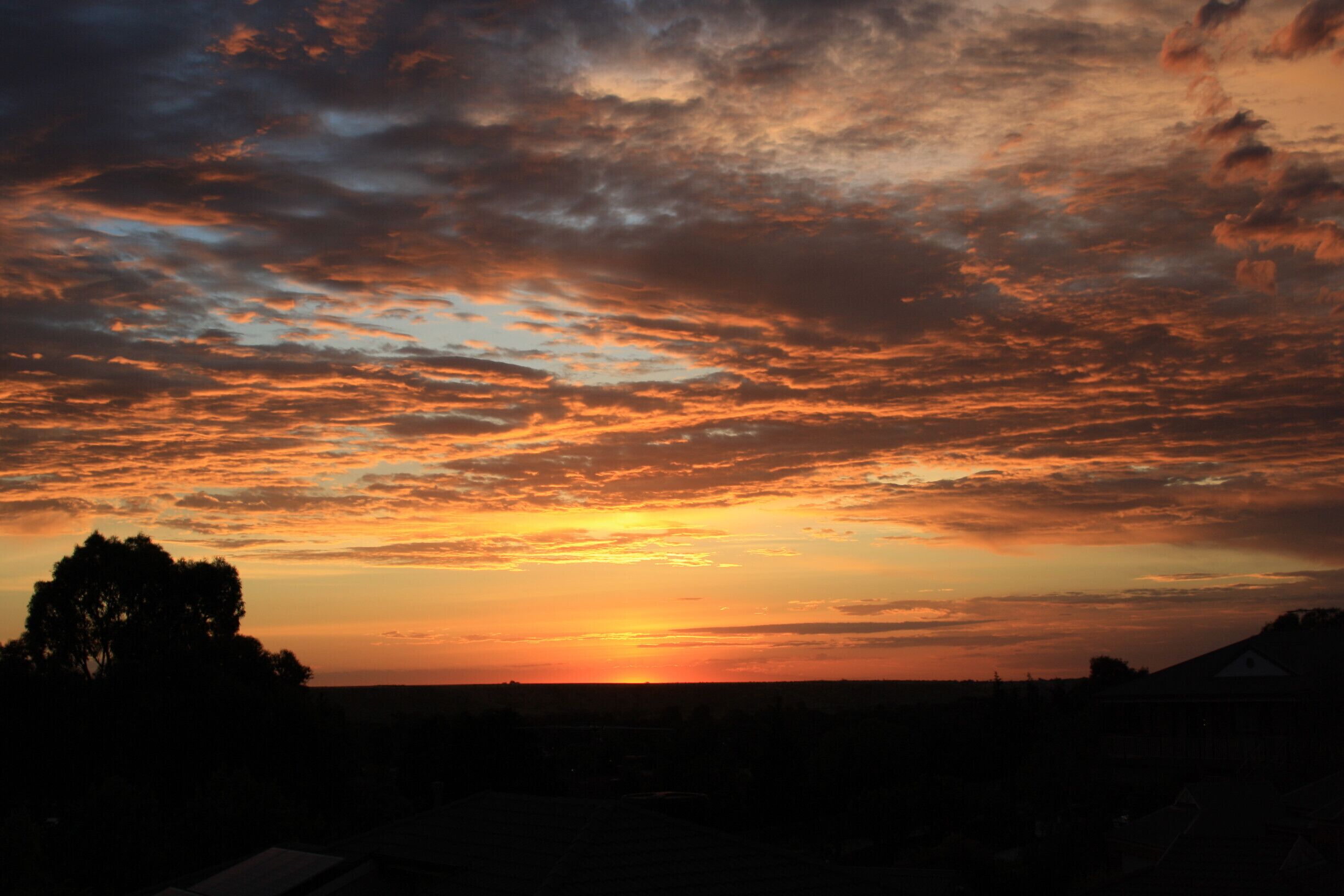 Sunrise in Darley near Bacchus Marsh, Victoria.   To the east, but below the  horizon is Melbourne 50km away.