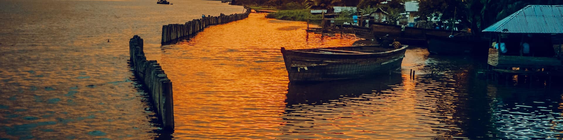 Nigeria, Delta State, Koko river and fishing village at sunset