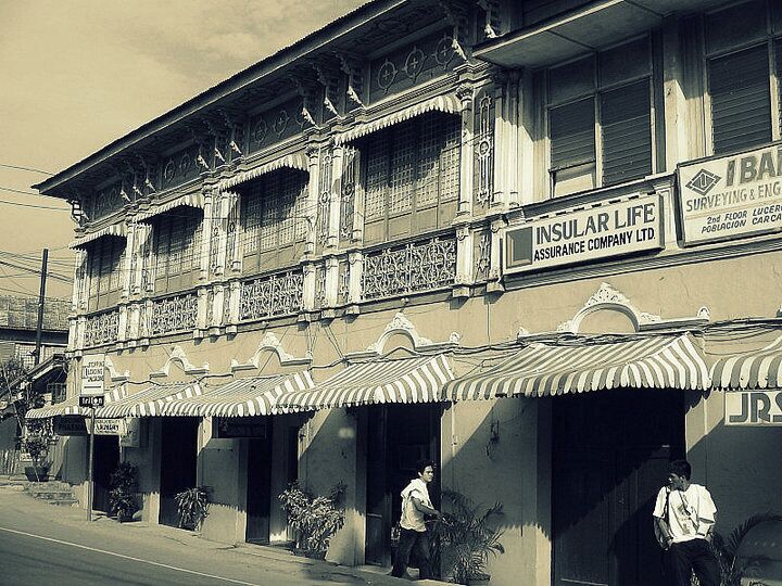 A building with ornate architectural details and signage for 'INSULAR LIFE Assurance Company Ltd.' and 'B.A. Surveying & Engineering'.