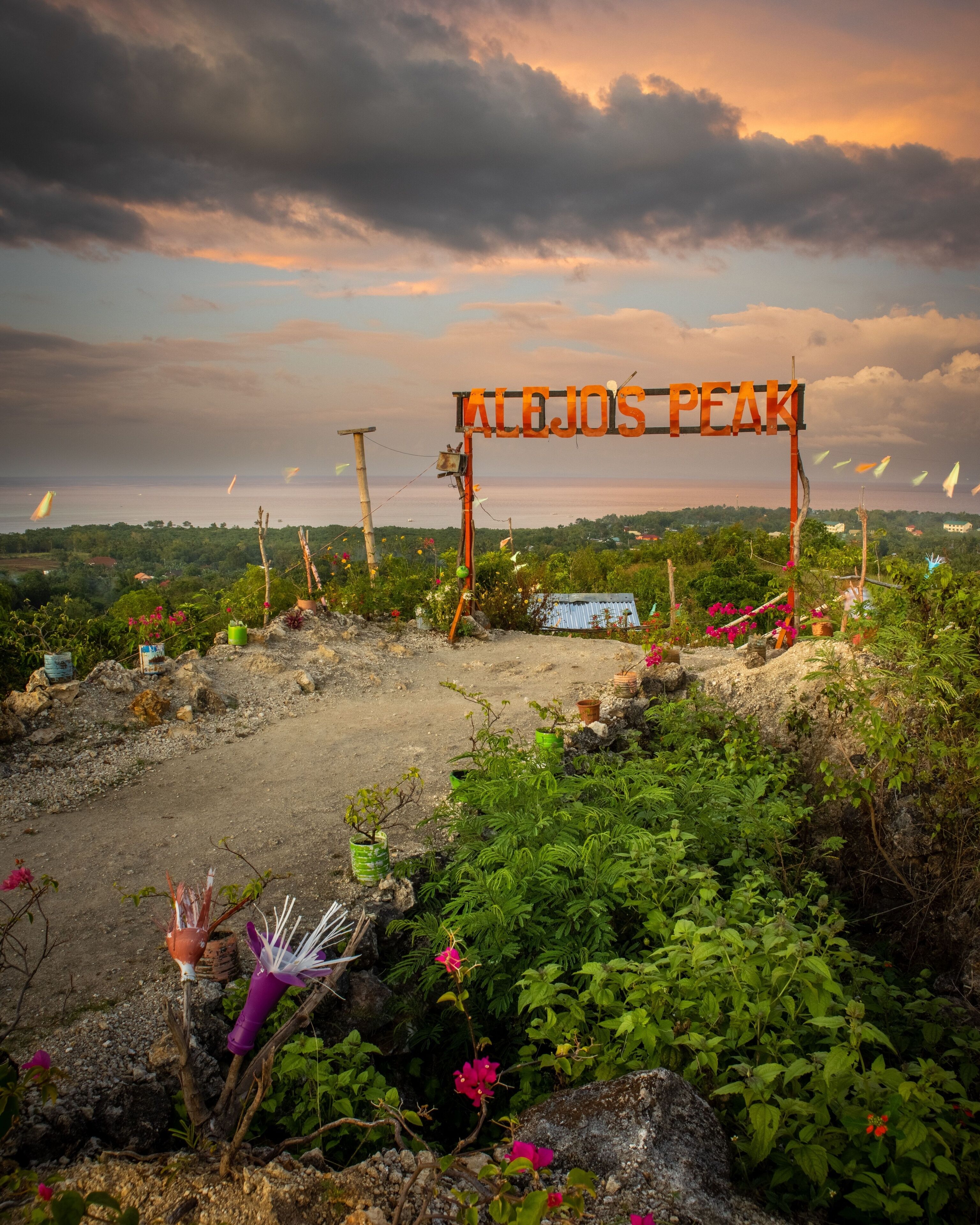 Scenic view of Alejo's Peak park with a sign in Bogo, Cebu, Philippines, at sunset