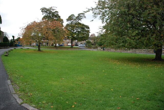 The village green Pilsley In the centre of the village and next to the village school.