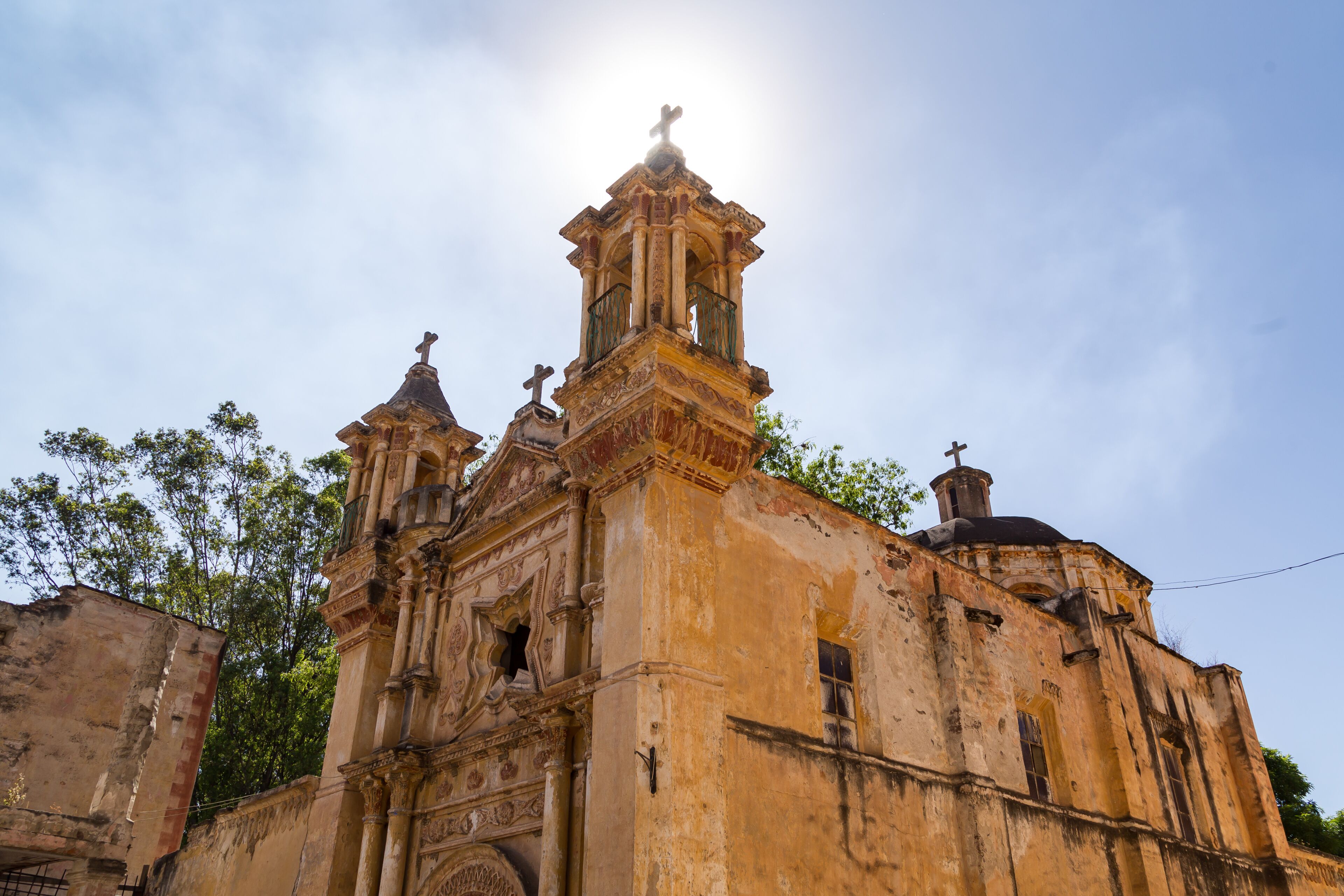 A historic church with ornate architecture, including a bell tower and statues.