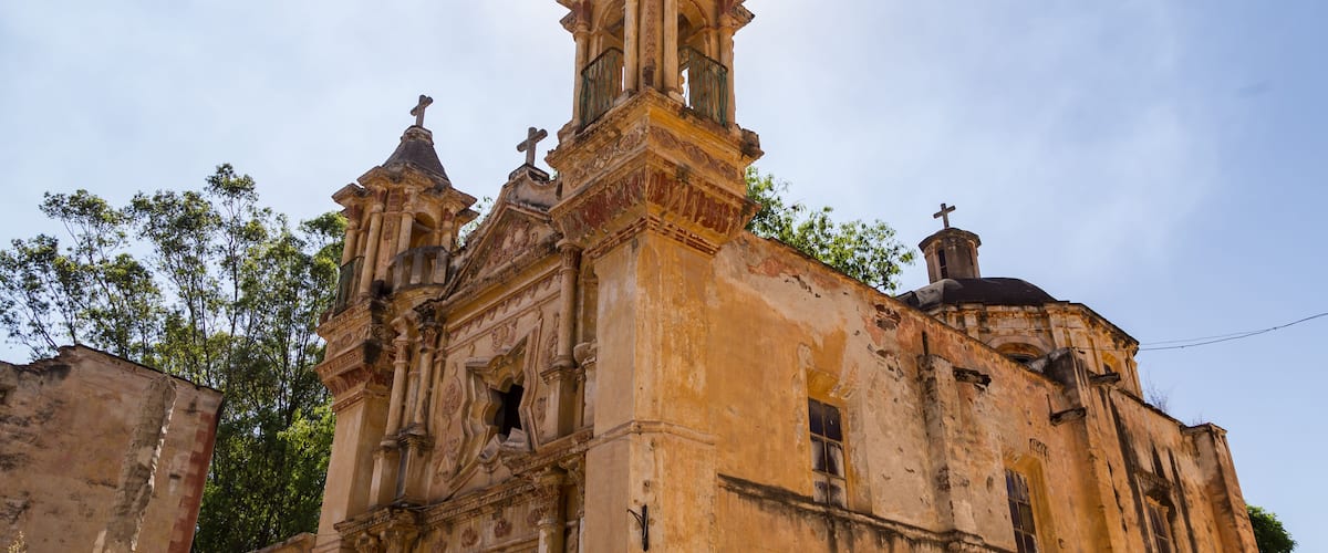 A historic church with ornate architecture, including a bell tower and statues.