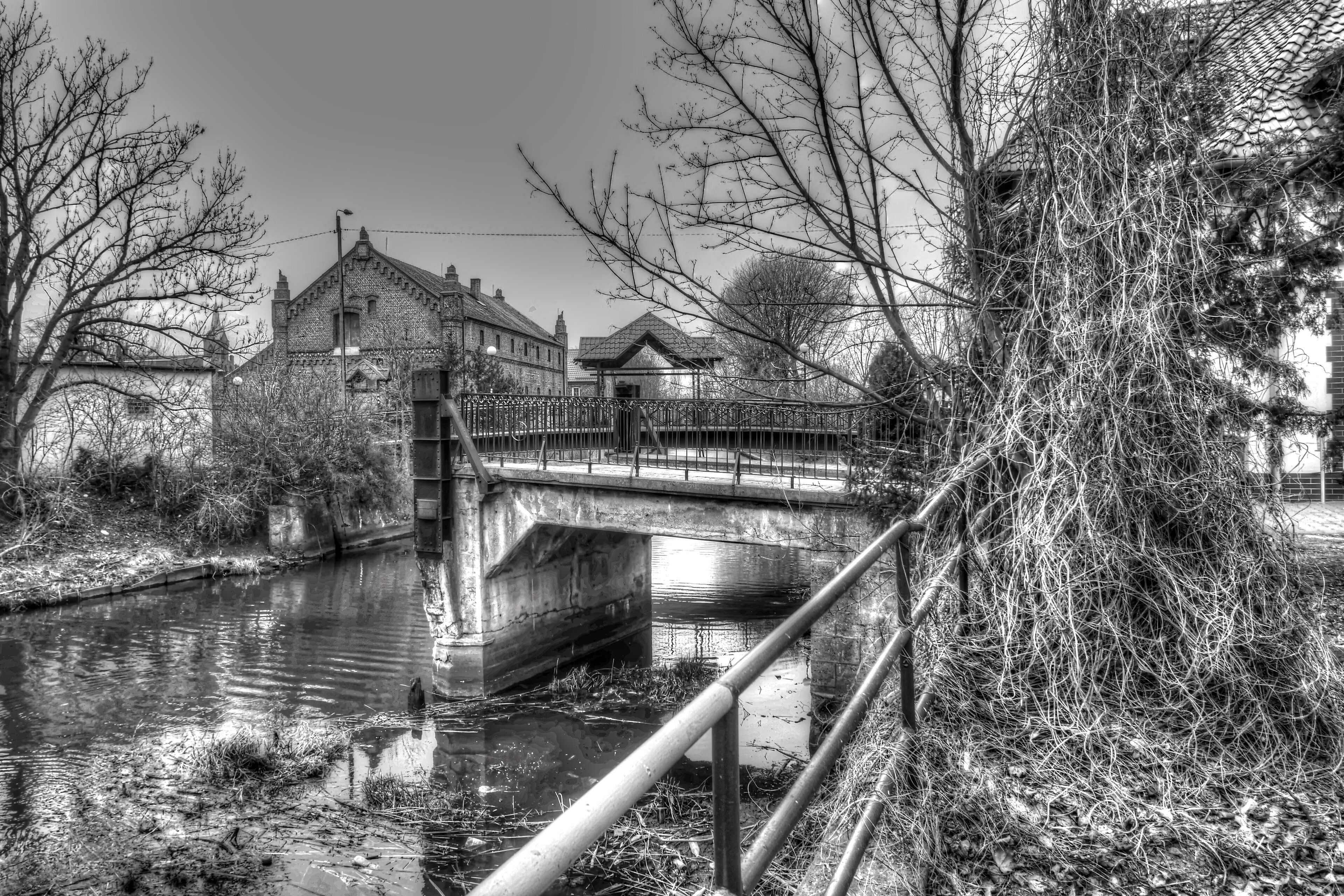 A bridge over a canal with buildings on either side.
