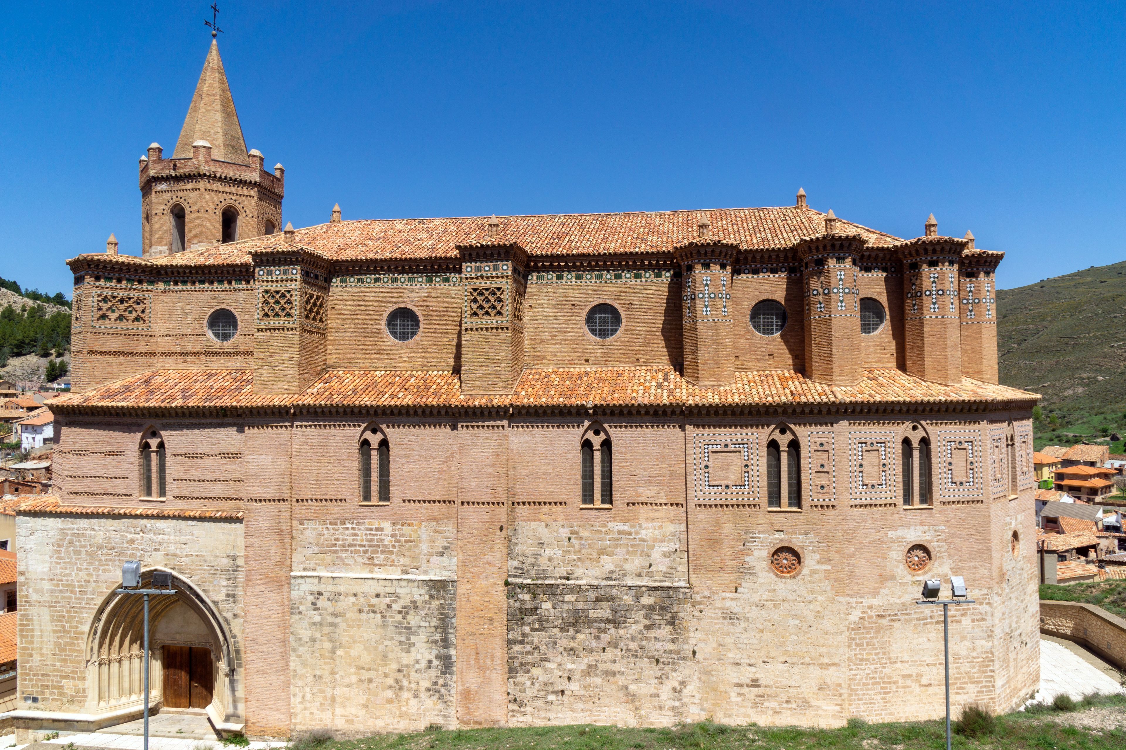 A historic church with a prominent bell tower and intricate tile roof.