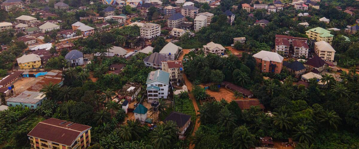 A densely populated urban area with numerous buildings and scattered greenery.