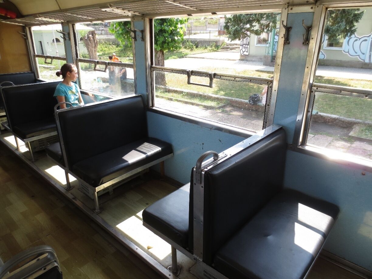 View from a railway station in the country of Georgia - girl peering out the window.

There's a train in Georgia that runs between the resort towns of Borjomi and Bakuriani.  This particular picture was taken in Bakuriani.