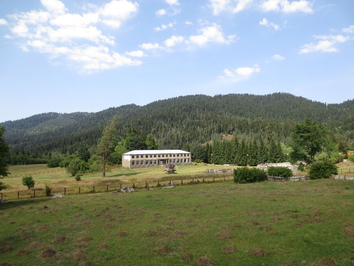 View from a train.  This picture was taken out the window of a moving train, just as the train was leaving the resort area of Bakuriani in the country of Georgia.

There's an inexpensive train that runs between Borjomi and Bakuriani - the train ride provides some beautiful views of the countryside.  