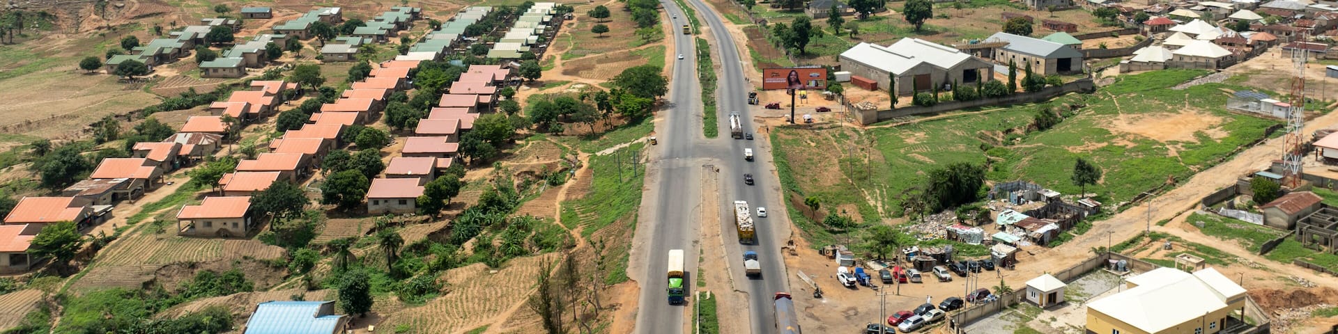Aerial view of zuma rock surrounded by urban homes and rural landscape, Suleja, Nigeria.