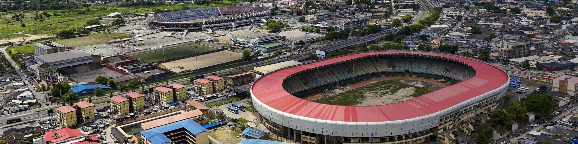 Aerial view of the National Stadium and Teslim Balogun Stadium stand boldly against a backdrop of dense urban sprawl, Lagos, Lagos, Nigeria.