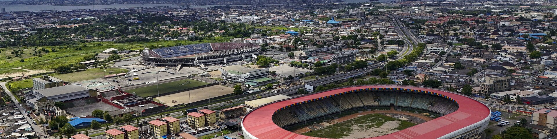 Aerial view of the National Stadium and Teslim Balogun Stadium stand boldly against a backdrop of dense urban sprawl, Lagos, Lagos, Nigeria.