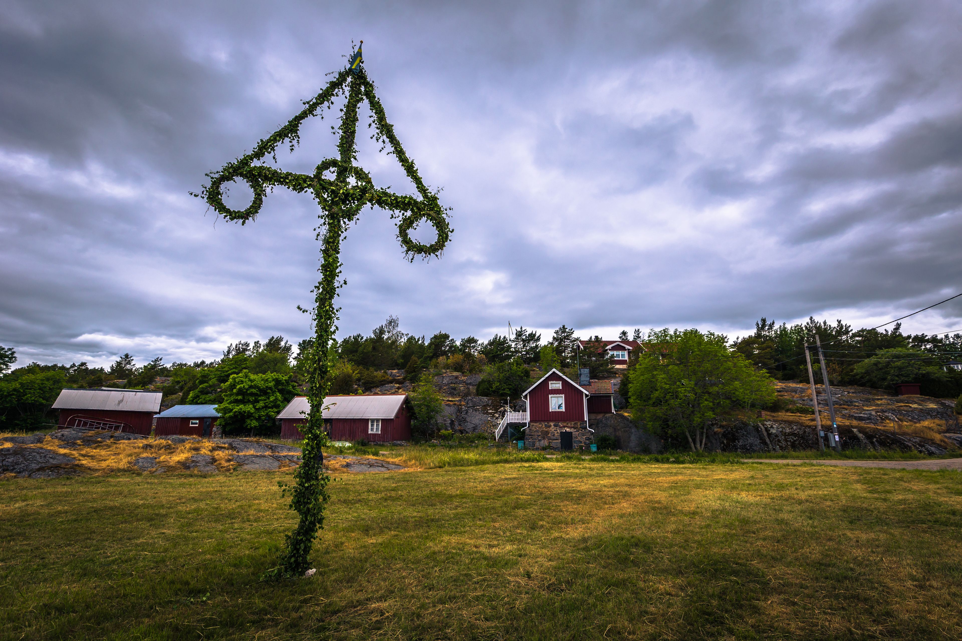 Swedish Archipelago - June 23, 2018: Midsummer pole in the island of Moja in the Swedish Archipelago during Midsummer, Sweden