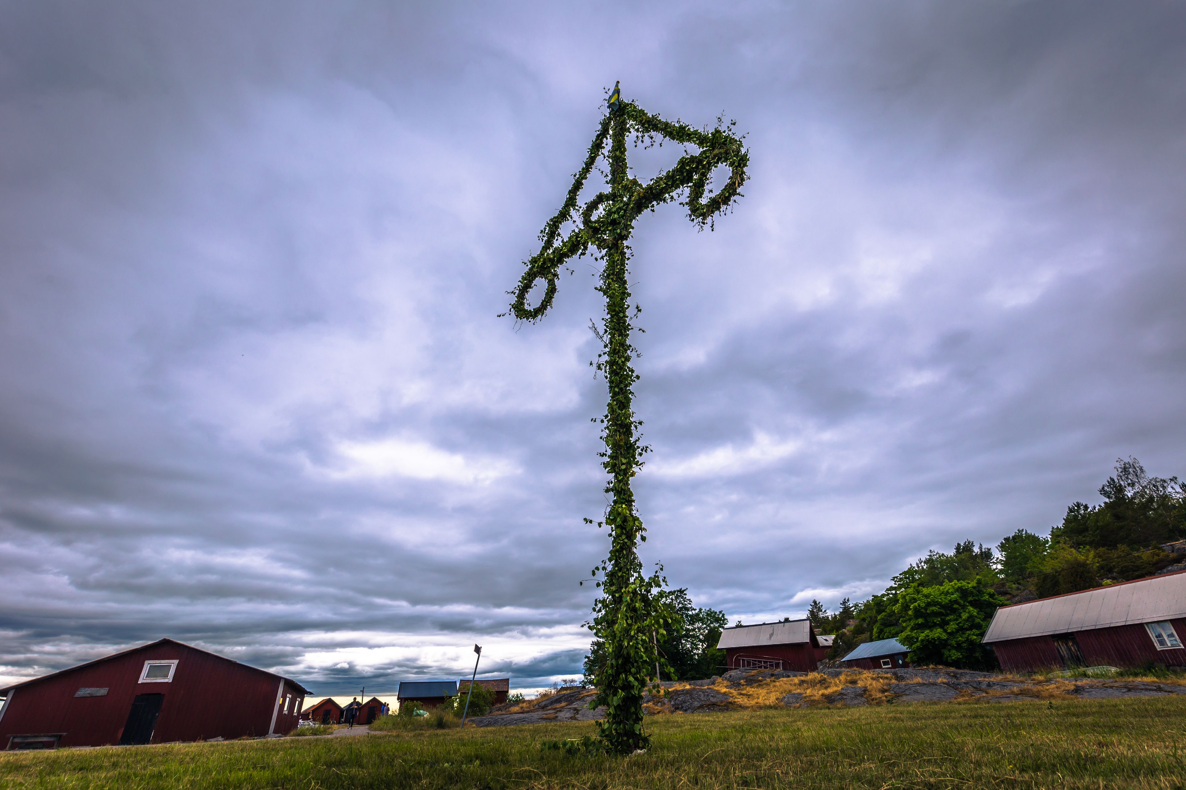 Swedish Archipelago - June 23, 2018: Midsummer pole in the island of Moja in the Swedish Archipelago during Midsummer, Sweden