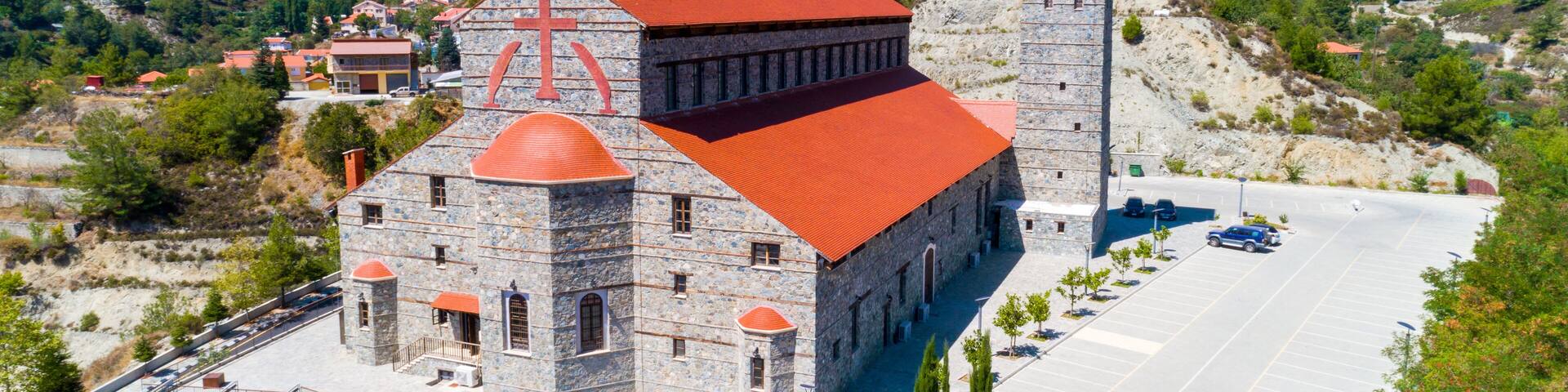 Aerial view of Agios Arsenios church, Kyperounda village, Limassol, Cyprus. Traditional landmark christian greek orthodox, ceramic tiled roof, stone bell tower architecture in Kyperounta from above