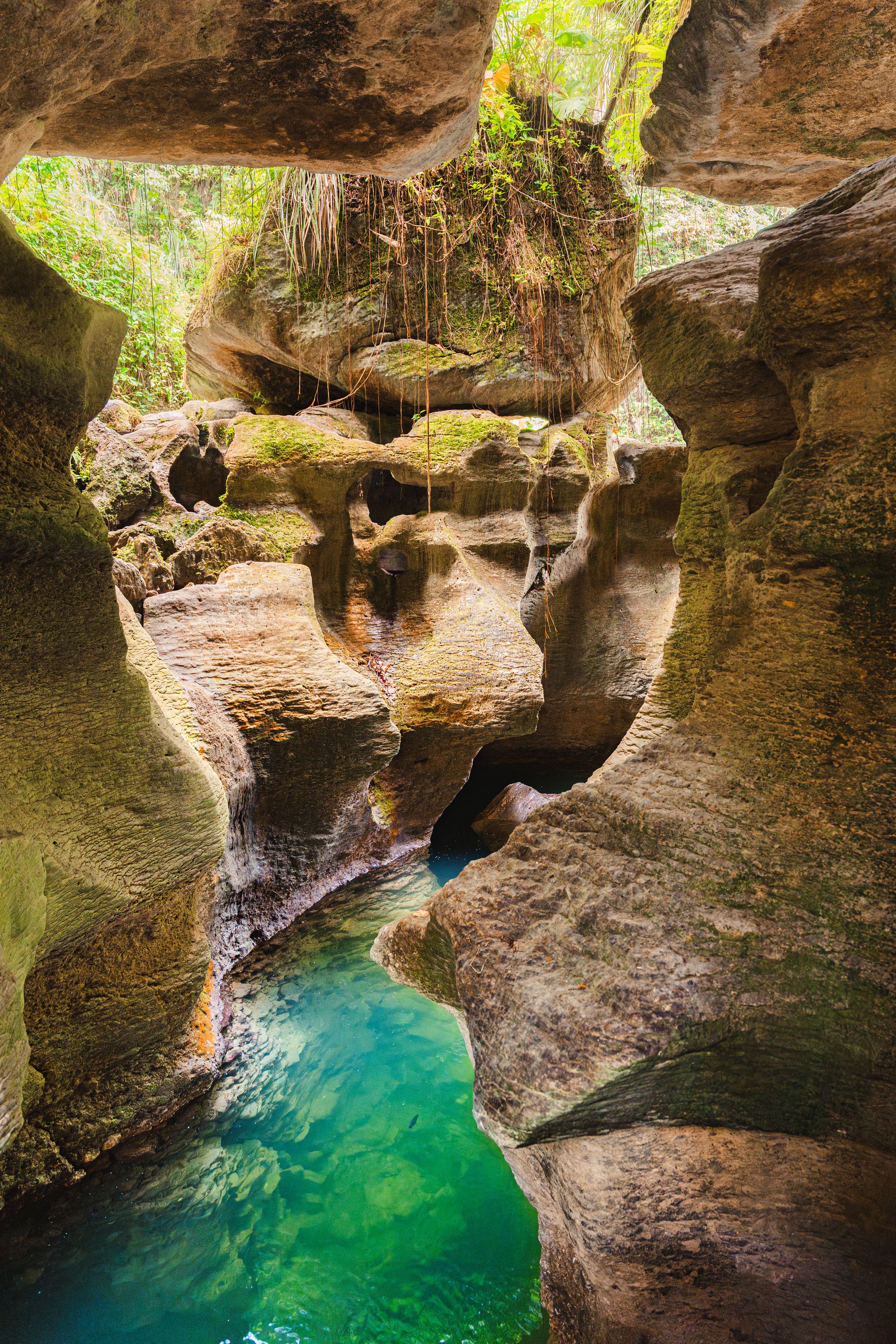 A natural rock formation with a clear water stream.