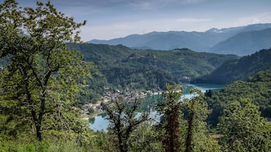 A mountainous landscape with a lake and a small town nestled in the valley.