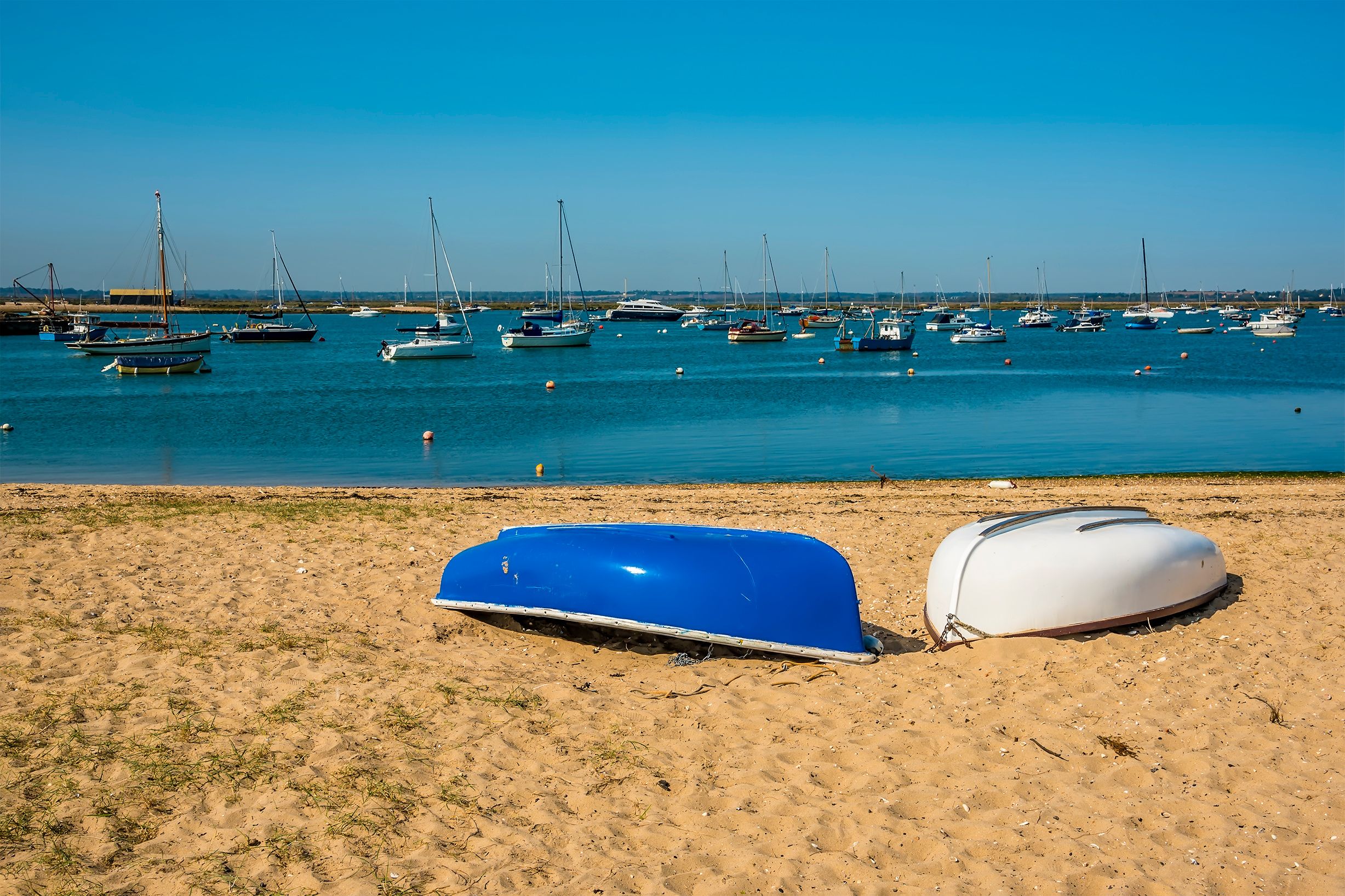 A view towards boats moored in Blackwater estuary from West Mersea, UK in the summertime