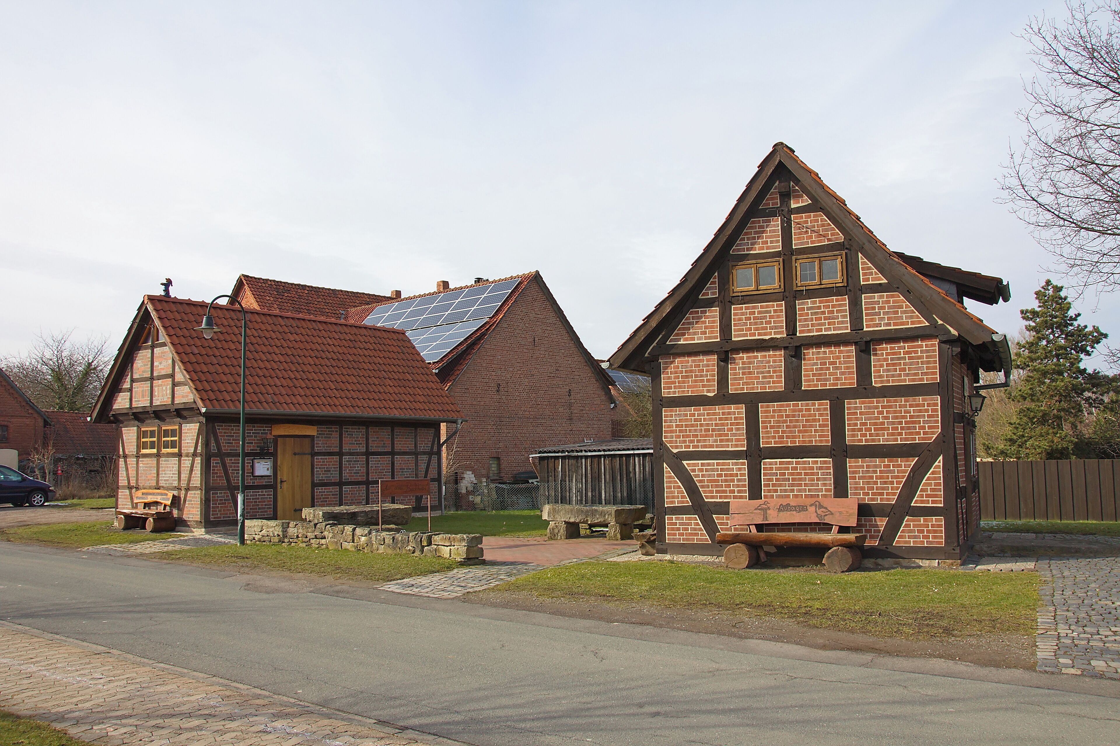 A traditional half-timbered house with a sloped roof and solar panels.