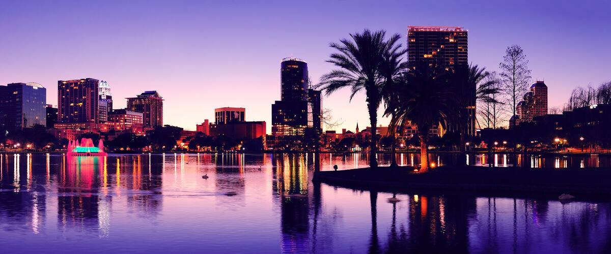 Orlando downtown skyline panorama silhouette over Lake Eola at dusk with urban skyscrapers