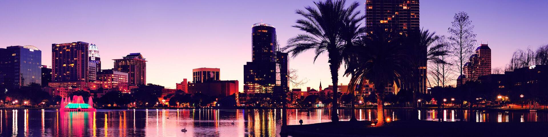 Orlando downtown skyline panorama silhouette over Lake Eola at dusk with urban skyscrapers