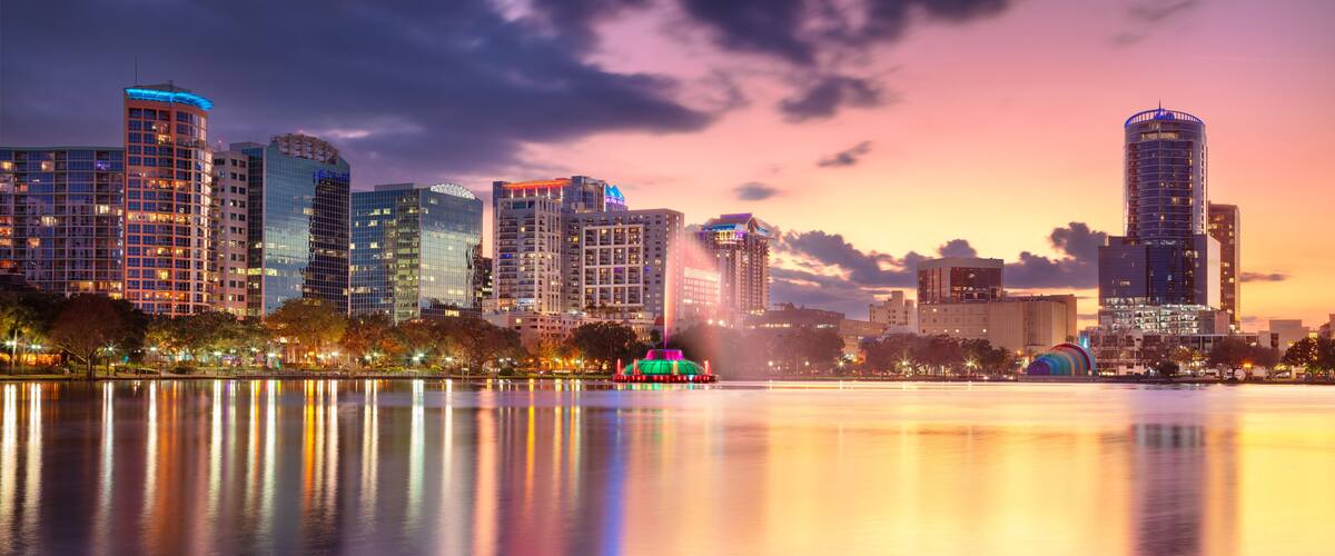 Orlando, Florida, USA. Cityscape image of Orlando, Florida with reflection of the city skyline in the water at beautiful sunset.