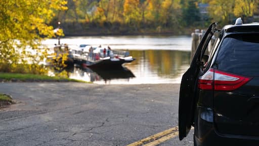 Family minivan waiting for New England traditional ferry to offload vehicles and people to cross the Connecticut River.