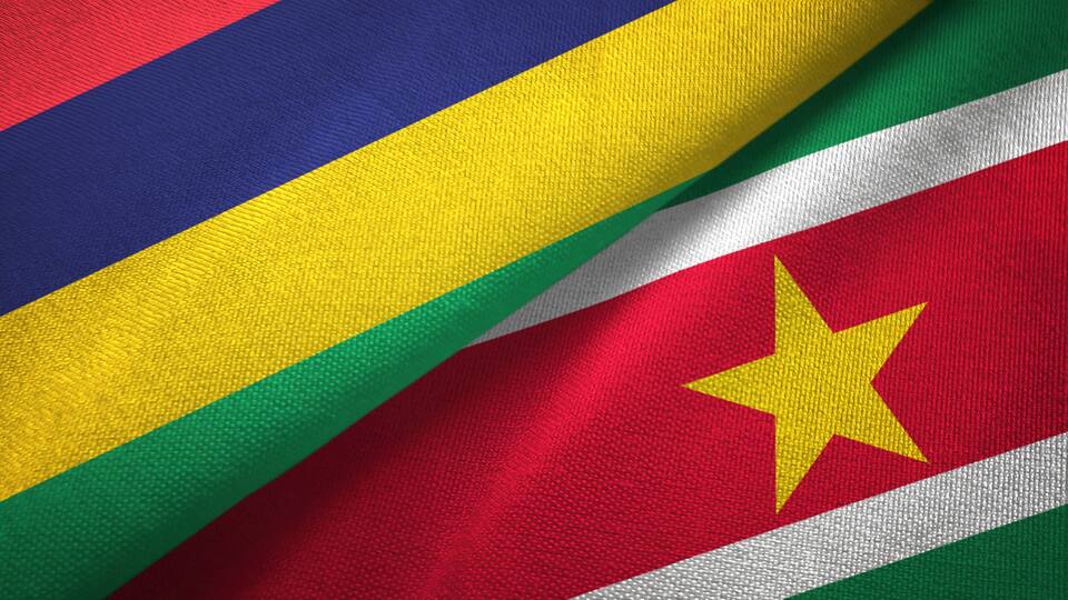 A flag with horizontal stripes of blue, yellow, green, and red, and a yellow star on the red stripe.